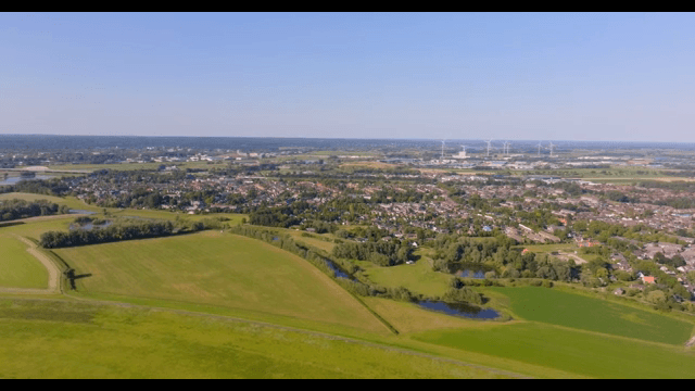 Aerial view of a village surrounded by fields and trees