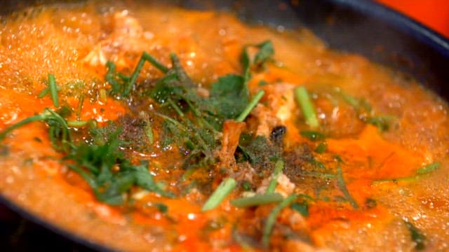 Spicy shaggy sea raven stew boiling in a pot