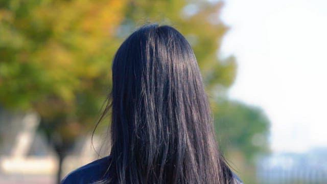 Woman tying her hair outdoors