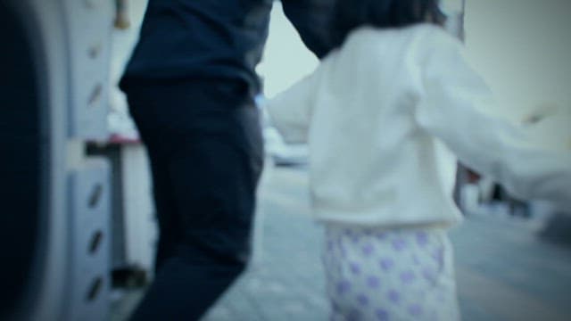 Adult and Child Walking away from Bicycle