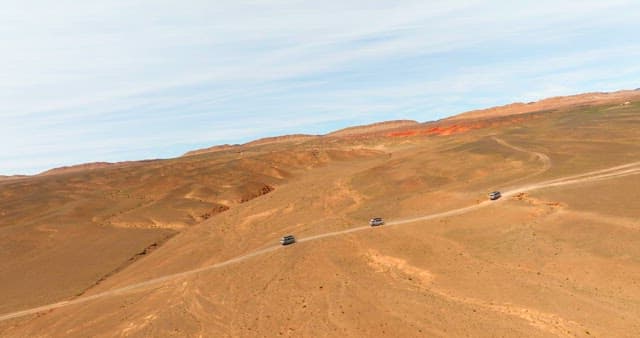 Vehicles traveling through a desert landscape
