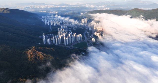 City skyline with clouds over mountains