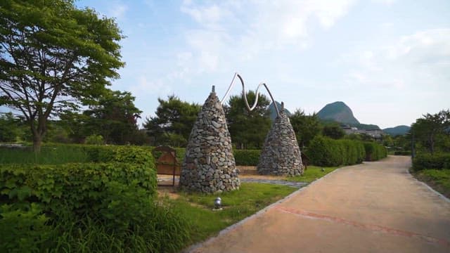 Stone towers with arching sculptures in park