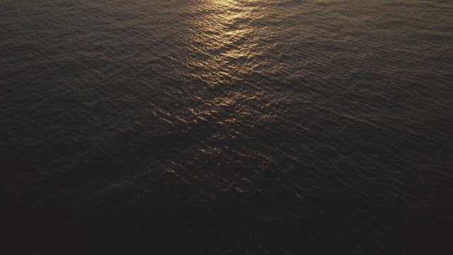 Sunset reflecting on calm ocean waves