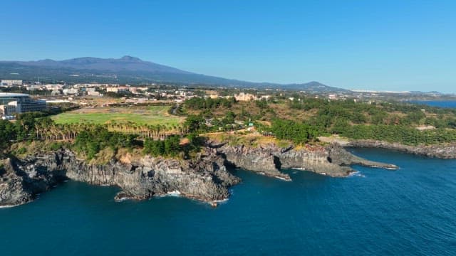 Coastal cliffs and distant cityscape