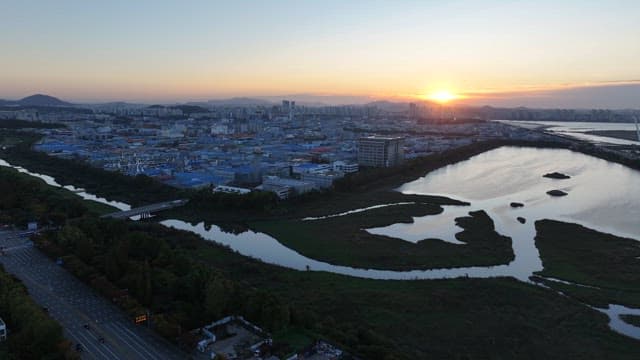 Sunset Over Urban Landscape and Sea