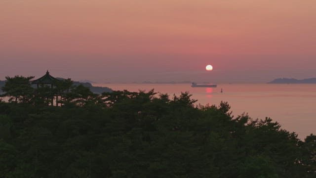 Sunset over the sea with a old pavilion