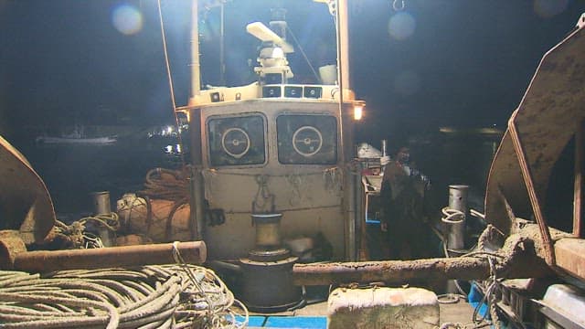 Fishing Boat Setting Sail in Preparation for Night Fishing