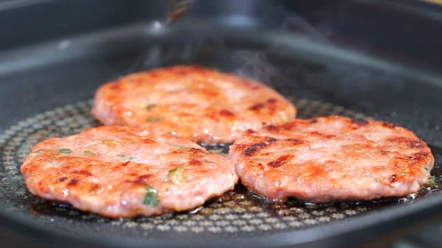 Tteokgalbi sizzling on a hot pan