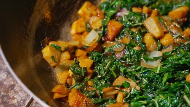 Sautéing spinach and tuna in a frying pan