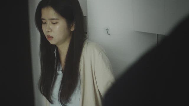 Woman walking around the room with a worried face