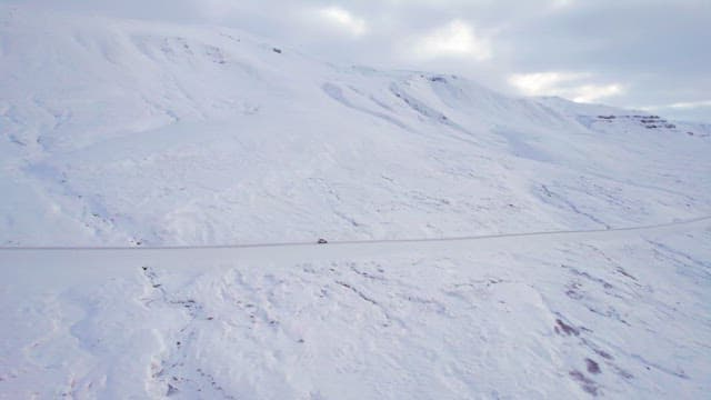 Car driving on a snowy mountain road