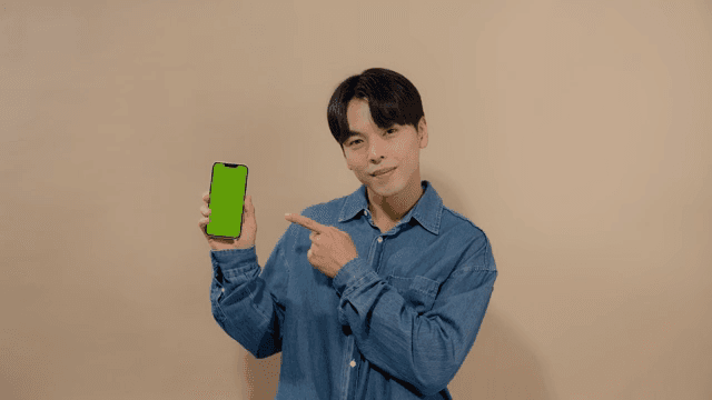 Man pointing his finger at the screen of his cell phone