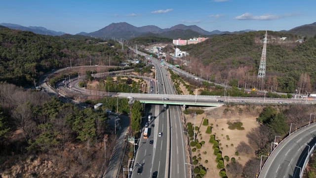 Highway surrounded by mountains and trees