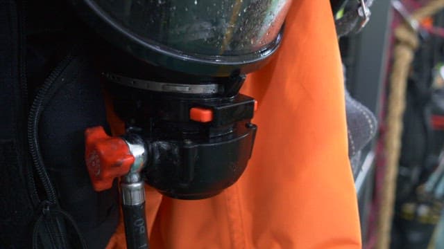 Masks and orange firefighter suits of firefighters