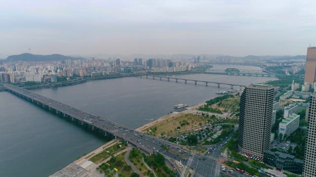 Bridge with Busy Cars and a Riverside in the City Center