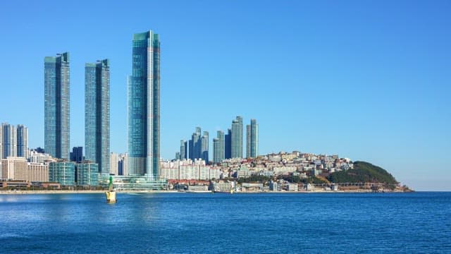 Busan's high-rise buildings and Dongbaekseom Island scenery from sunny day to night