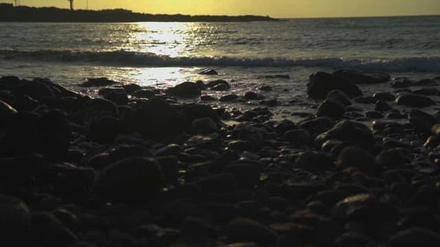 Serene Sunset Over a Rocky Coastal Landscape