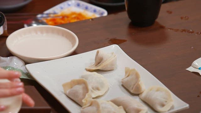 Making dumplings on a wooden table in a cozy kitchen
