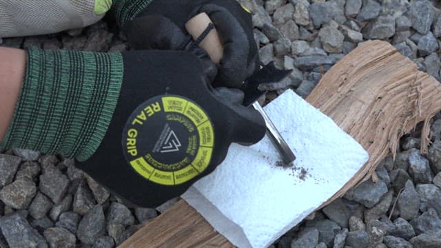 Close-up of hands lighting fire outdoors with fire starter sticks
