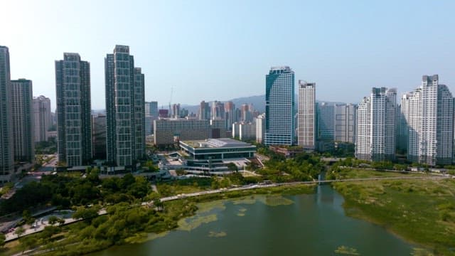Aerial view of a city with high-rise buildings and a lake