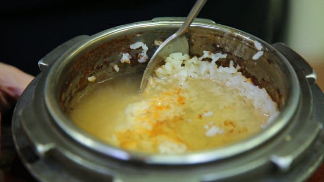Spoonful of scorched rice made by pouring water into a pot