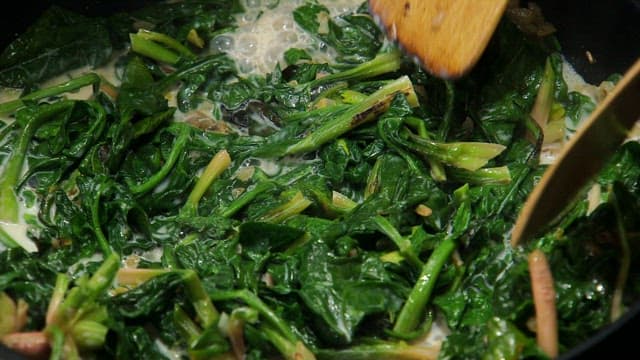 Spinach being cooked with flour