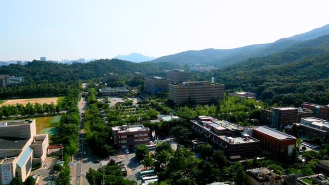 Square buildings surrounded by green mountains