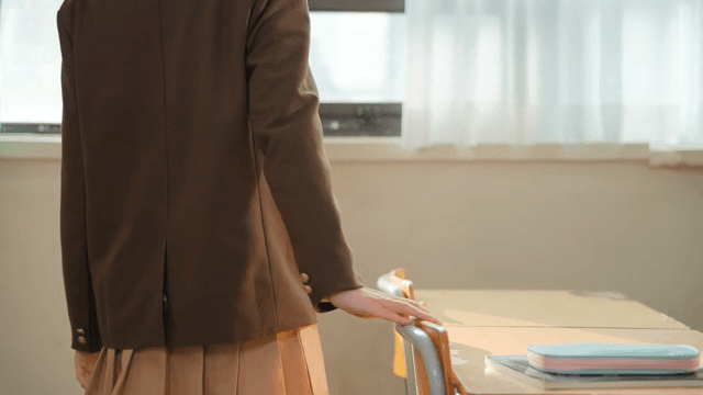 Student looking out the classroom window