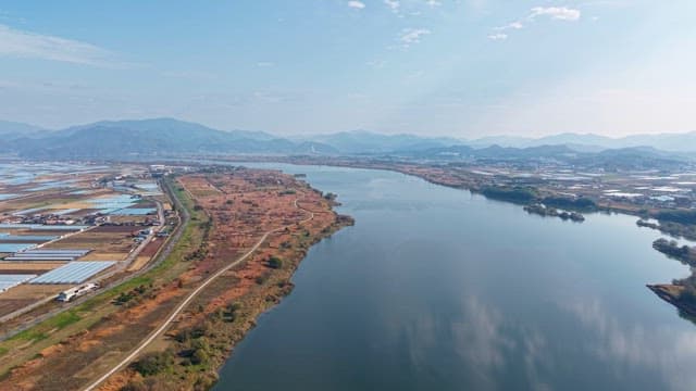Serene river flowing through farmland