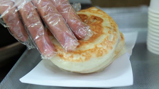 Korean hotteok on a paper plate