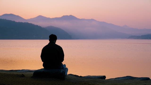 Man Contemplating by the Lake at Dawn