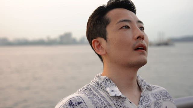 Man resting while leaning on a railing