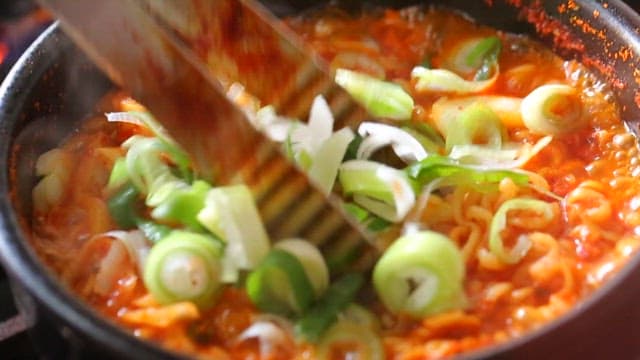 Korean ramen boiling with green onions