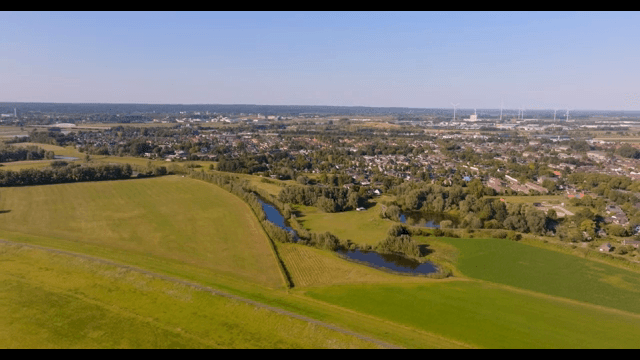 Aerial view of a village surrounded by fields and trees