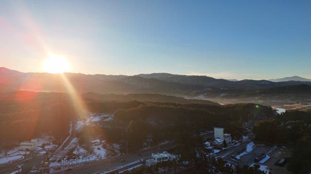 Sunrise over snowy mountains and forest