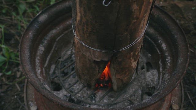 Firewood burning in a metal barrel