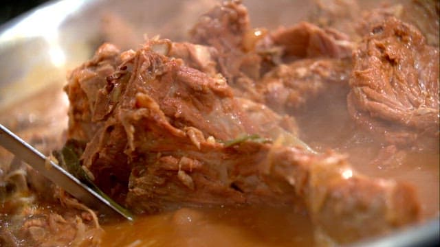 Scene of meat being taken out of pork backbone stew