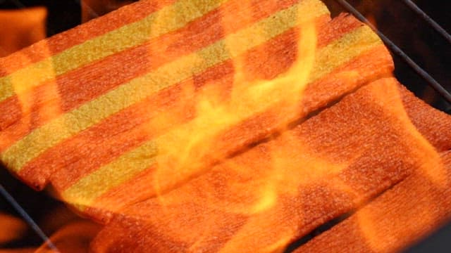 Jjondegi Being Grilled in a Flickering Flame