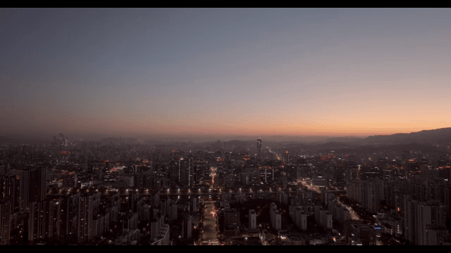 City skyline at dusk with glowing lights
