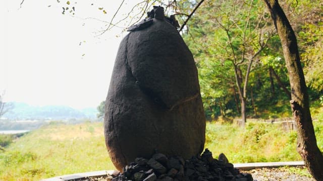 Lush trees and greenery surrounding the stone tower