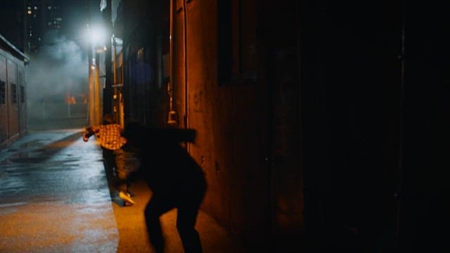 Nighttime Chase Scene in Urban Alleyway