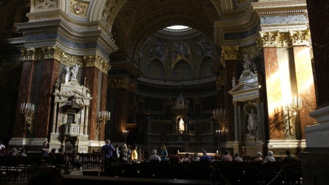 Interior of a Grand Ornate Cathedral with Tourists