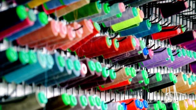 Colorful sewing thread hanging on the wall