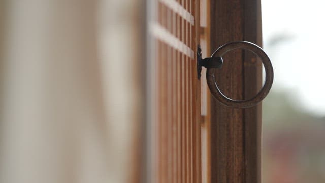 Metal doorknob on the wooden door of a traditional Korean house, Hanok