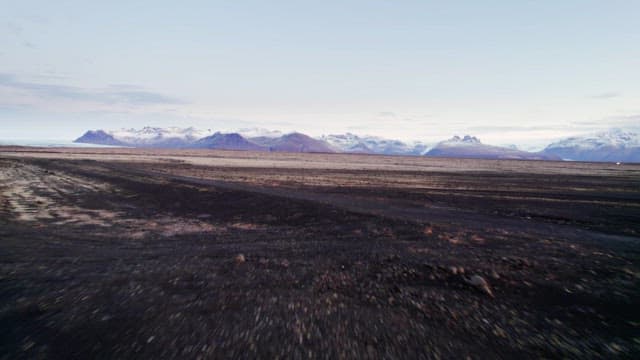 Vast landscape with distant snowy mountains