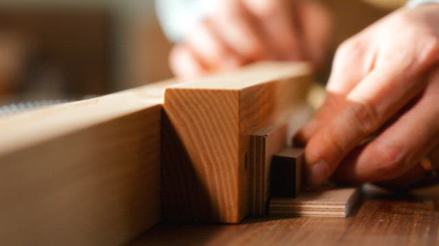 Craftsman Bringing Precision Cut Wooden Parts