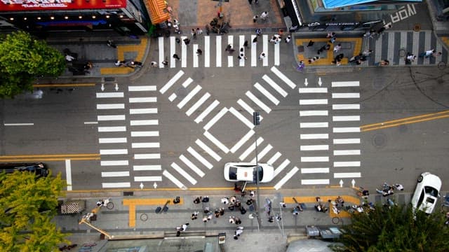 Busy city intersection filled with pedestrians crossing