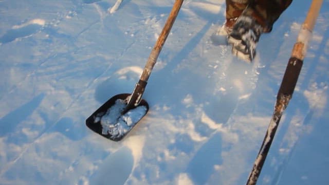 Traditional Ice Fishing in a Snowy Landscape
