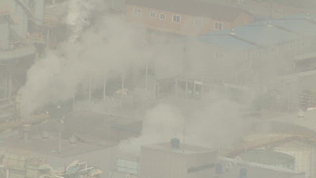 Aerial View of Industrial Complex with Smoke